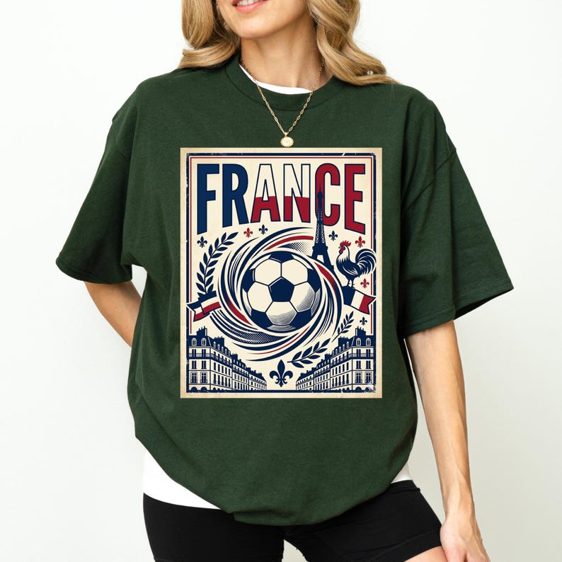 A woman wearing a green t-shirt with a graphic design featuring a soccer ball, a rooster, and various French-themed elements.