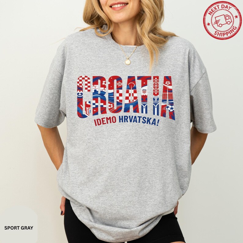 A woman wearing a grey t-shirt with the word "Croatia" printed on it.