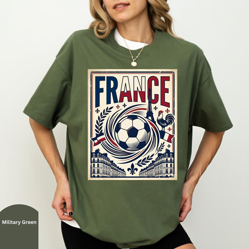 A woman wearing a green t-shirt with a graphic design of a soccer ball and various landmarks, including the Eiffel Tower, surrounded by the word "FRANCE".