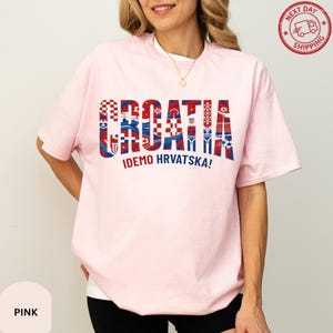 A woman wearing a pink t-shirt with the word "Croatia" printed on it.