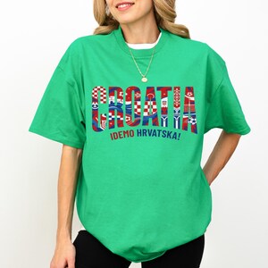 A woman wearing a green t-shirt with the word "Croatia" printed on it.