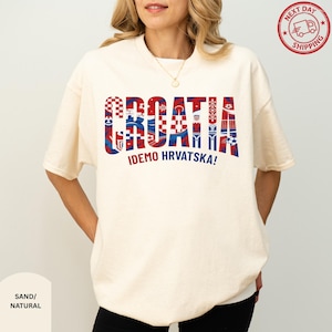 A woman wearing a white t-shirt with the word "Croatia" printed on it in a stylized manner.