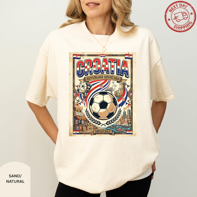 A woman wearing a white t-shirt with a graphic design featuring a soccer ball, a flag, and various elements related to the country of Croatia.