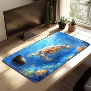 May include: A rectangular mouse pad featuring a vibrant underwater scene with a sea turtle swimming in blue water. The turtle has a brown and orange shell. A black computer mouse sits on the left side of the pad.