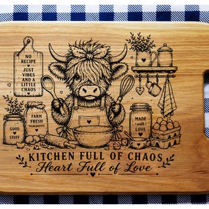 May include: Wooden cutting board with a whimsical kitchen-themed design. Features a Highland cow illustration with cooking utensils and text that reads "Kitchen Full of Chaos, Heart Full of Love". Includes a handle for easy use.