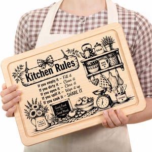 May include: A rectangular wooden chopping board featuring a laser-engraved design with the text Kitchen Rules, a list of household instructions, and illustrations of kitchen items including a shelf, a scale, a flower pot, and a bowl of fruit.