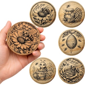 May include: A collection of six round wooden coasters with intricate laser-cut designs. Each coaster features a bee-themed illustration, including bees, honeycombs, flowers, and honey pots. The coasters are made of light-colored wood.