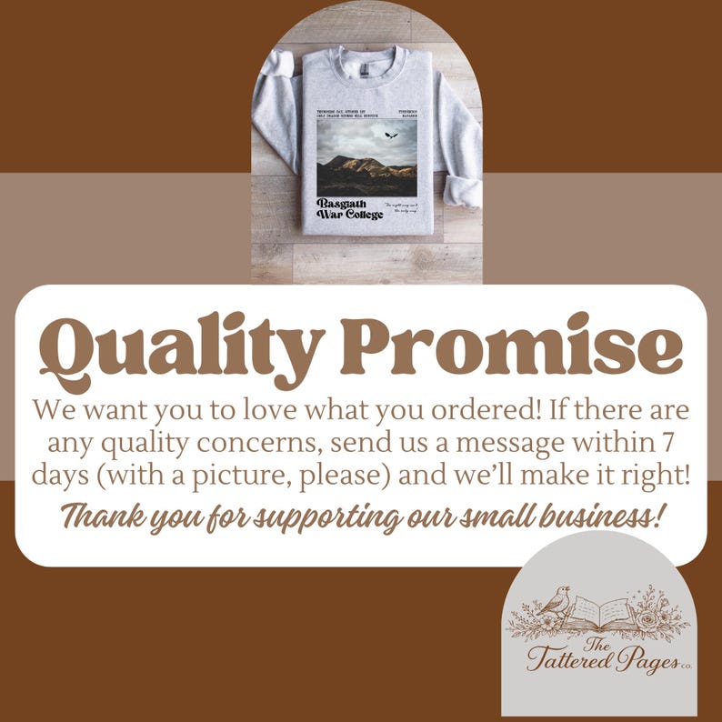 May include: A light gray sweatshirt with a graphic featuring a mountain landscape and the text "Basgiath War College." The sweatshirt is folded on a wooden surface. The image also includes text about a quality promise.