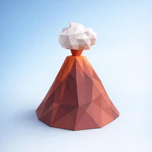 May include: A papercraft volcano model with a geometric design. The volcano is primarily shades of brown and orange, with a white cloud-like structure at the top. The model is set against a light blue background.