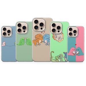 May include: Five phone cases with dinosaur illustrations in various colours. The cases feature cartoon dinosaurs in green, orange, blue, and pink. Each case has a different background colour, including blue, green, and tan. The designs are playful and vibrant.