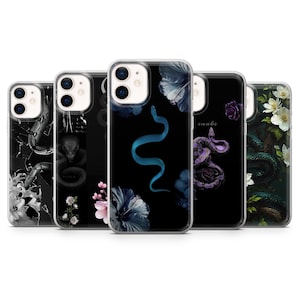 May include: A selection of smartphone cases with different designs. The cases display images of snakes, flowers, and botanical elements in black, white, blue, and purple. The cases are designed to fit a mobile phone.