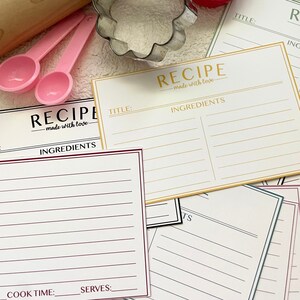 May include: A set of printable recipe cards with a white background and black text. The cards have a title, ingredients, directions, time, cook time, and serves sections. The cards are decorated with a gold, red, and green border.