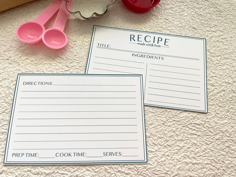 May include: Two blank recipe cards with a blue border. The top card has the text "RECIPE made with love" and "INGREDIENTS". The bottom card has the text "DIRECTIONS", "PREP TIME", "COOK TIME", and "SERVES".