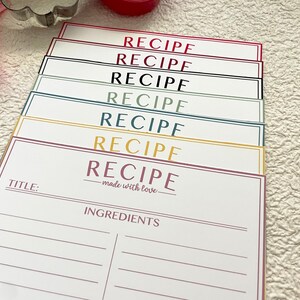 May include: A stack of colorful recipe cards with the word "RECIPE" printed on each card. The top card has the text "made with love" and a space for a title and ingredients.