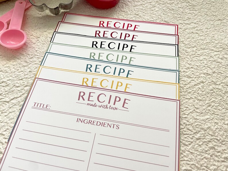 May include: A stack of colorful recipe cards with the word "RECIPE" printed on each card. The top card has the text "made with love" and a space for a title and ingredients.