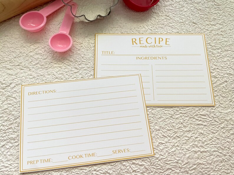 May include: Two blank recipe cards with gold trim and lines. The top card has the title "RECIPE made with love" and the heading "INGREDIENTS". The bottom card has the headings "DIRECTIONS", "PREP TIME", "COOK TIME", and "SERVES".