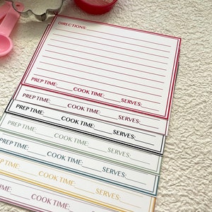 May include: A set of seven recipe cards with blank lines for writing down directions, prep time, cook time, and servings. The cards are in different colors: red, green, black, blue, and yellow.