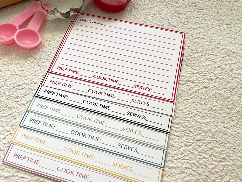 May include: A set of seven recipe cards with blank lines for writing down directions, prep time, cook time, and servings. The cards are in different colors: red, green, black, blue, and yellow.