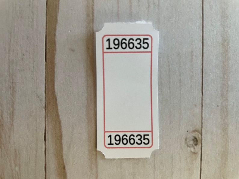 May include: White ticket with a red border and the number 196635 printed on the top and bottom.