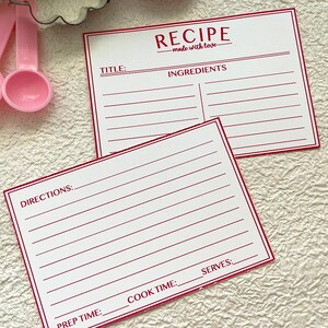 May include: Two blank recipe cards with red lines and the text "RECIPE - made with love -" at the top of the card. The cards are labeled "TITLE", "INGREDIENTS", "DIRECTIONS", "PREP TIME", "COOK TIME", and "SERVES".