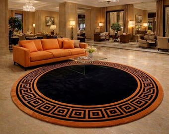 Modern rund matta – Svart cirkelmatta med orange kant – Minimalistisk geometrisk matta – Trendig golvdekor för vardagsrum