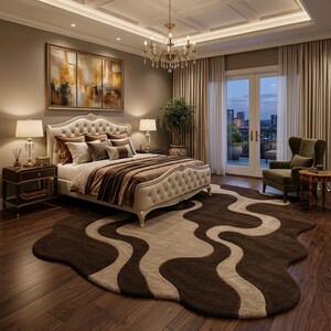 May include: A luxurious bedroom featuring a tufted headboard bed with brown and beige bedding. A large abstract painting hangs above the bed. A brown and beige wavy rug covers the hardwood floor. A chandelier hangs from the ceiling.