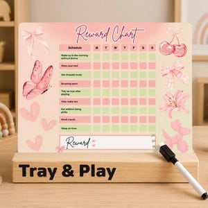 May include: A rectangular reward chart with a pink and cream gradient background, featuring illustrations of a butterfly, cherries, bows, a flower, and a balloon dog. The chart includes a schedule grid with tasks, days of the week, and a reward section.