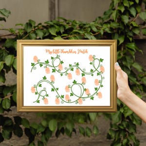 May include: A framed print featuring the text My little thumbkin Patch in orange script, accompanied by green illustrated vines and numerous peach-colored thumbprint shapes arranged along the stems on a white background.