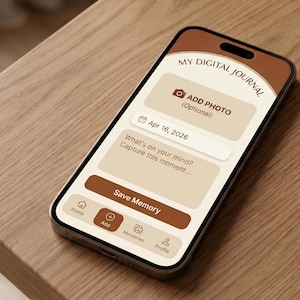 Puede incluir: Un smartphone que muestra la interfaz de una aplicación de diario digital. La pantalla muestra el texto "MY DIGITAL JOURNAL" en la parte superior, con opciones para agregar una foto, una fecha y un espacio para escribir. El teléfono está sobre una superficie de madera.