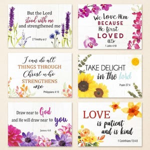 May include: A set of six rectangular wall art prints featuring floral illustrations and religious scripture text. Each print displays a unique verse with colorful flowers including lavender, orchids, sunflowers, and daisies on a white wood background.