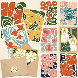 May include: A collection of rectangular greeting cards featuring various floral illustrations in vibrant colors including orange, yellow, pink, white, and green. One card is tucked into a brown paper envelope sealed with a circular floral sticker.