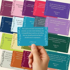 May include: A collection of rectangular cards in various colors, each featuring a white vine border and printed Bible verses from the NKJV. One teal card is held in the foreground, displaying 2 Peter 3:9, while other cards in shades of red, blue, green, and purple are arranged behind it.