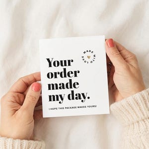 May include: A white rectangular card with black text that reads Your order made my day. Below this, smaller text reads I hope this package makes yours! A circular stamp design at the top right says Made with love with a small gold heart.