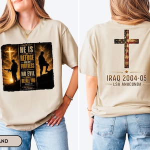 May include: A sand-colored t-shirt featuring a graphic on the front and back. The front displays a soldier silhouette, a cross, and the text HE IS MY REFUGE AND MY FORTRESS NO EVIL SHALL BEFALL YOU. The back features a cross with an American flag pattern.