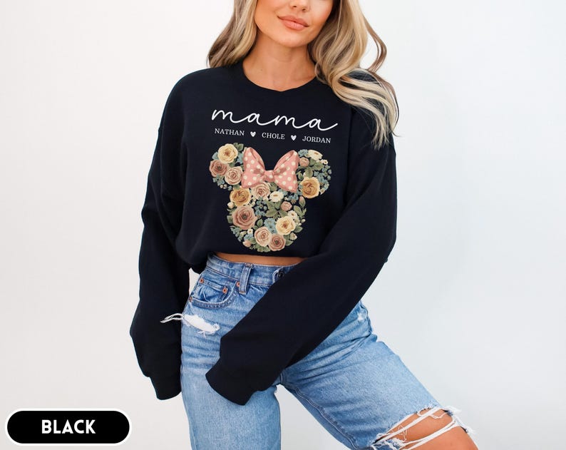 May include: Black sweatshirt with the word "mama" in white script. Below the word "mama" are the names "Nathan", "Chole", and "Jordan". The sweatshirt features a floral Minnie Mouse head design with a pink bow.