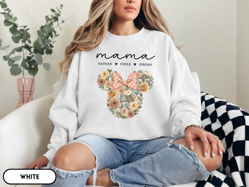 May include: White sweatshirt with the word "mama" in script above the names Nathan, Chole, and Jordan. A floral Mickey Mouse head design with a pink polka dot bow is featured on the front.