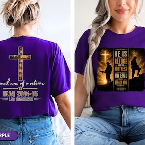 May include: A purple t-shirt featuring a graphic on the back with a cross patterned like the American flag, the text "proud mom of a veteran", "IRAQ 2004-05", and "LSA ANACONDA". The front displays a soldier silhouette and "HE IS MY REFUGE".