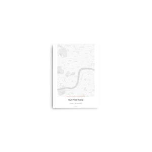 May include: A framed map print featuring a detailed, grayscale depiction of a city, likely London, with a red line highlighting a specific area. The text "Our First Home" is centered below the map, with the location and date printed below.