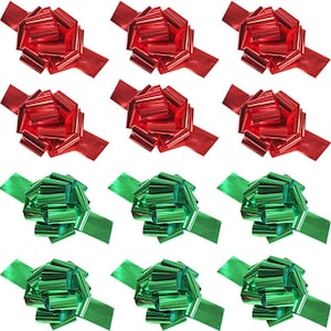 May include: Nine decorative gift bows in red and green. The bows are arranged in three rows of three, with the top two rows in red and the bottom row in green. Each bow has a ribbon tail.