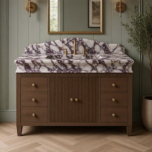 May include: A bathroom vanity featuring a white and purple marble countertop with a gold faucet. The base is made of dark brown wood with vertical fluted detailing on the central cabinet doors and six drawers with small gold knobs.