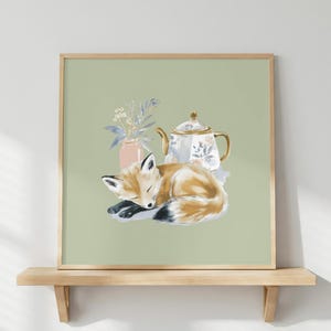 May include: A square framed print on a light green background featuring a watercolor illustration of a sleeping fox curled up next to a white teapot with floral patterns and a small pink vase containing delicate white flowers and blue leaves.