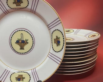 12 platos de postre de porcelana de Limoges de Lanternier & Co., decorados con cestas de frutas y canastas.