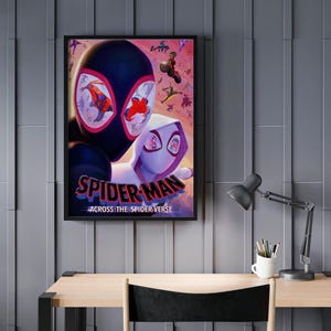 May include: Framed poster featuring Spider-Man characters from the movie "Across the Spider-Verse." The artwork showcases Miles Morales and Spider-Gwen, with a vibrant, action-packed design. The poster is displayed on a gray wall above a wooden desk.
