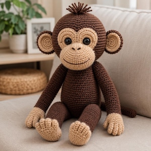 May include: A crocheted monkey stuffed animal featuring dark brown yarn for the body, head, arms, and legs, with light tan yarn accents on the face, ears, hands, and feet. The monkey has large black safety eyes and a small tuft of brown hair.