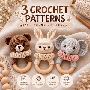 May include: Three crochet patterns for a bear, bunny, and elephant, each featuring a stuffed animal head attached to a wooden ring. The bear is brown, the bunny is cream, and the elephant is grey with a pink ruffled collar.
