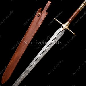 May include: A decorative sword with a patterned blade, wooden handle, and gold detailing. The sword is shown with a brown leather sheath. The design features intricate details and a classic aesthetic.