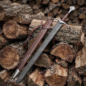 May include: A steel sword with a distinct wavy pattern on the blade, a silver crossguard, and a brown leather-wrapped handle. The sword is accompanied by a matching brown leather scabbard featuring a silver metal tip and leather strap attachments.