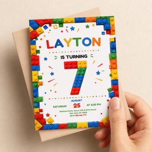 May include: A birthday invitation card featuring a border of colorful plastic building blocks. The text reads: LAYTON IS TURNING 7, AUGUST 25, SATURDAY AT 2:00 PM, Rainbow Party Venue, 125 W 57th Street, New York, NY 10019, RSVP 555-666-777.