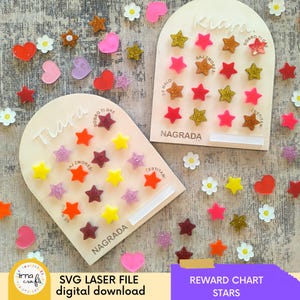 May include: Two wooden reward charts with star-shaped markers in various colors, including red, gold, and pink. The charts are labeled "Tiara" and "Kiara" with the word "Nagrada" below. Scattered around are star, heart, and flower-shaped decorations. The image also includes the text "SVG LASER FILE digital download" and "REWARD CHART STARS".