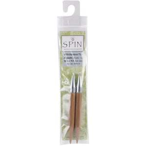 May include: A pair of 4-inch (10 cm) long, size 13 (9.0 mm) interchangeable bamboo knitting needles with silver tips. The needles are packaged in a clear plastic bag with a green and white label that reads "SPIN Bamboo Interchangeables" and "SPIN Bamboo Tip".